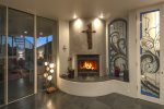 Living Room Fireplace with Gorgeous Stained Glass Art Hiding a TV and Entertainment Center